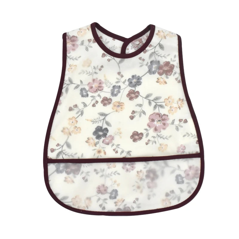 White baby feeding bib with floral pattern and a catch pocket