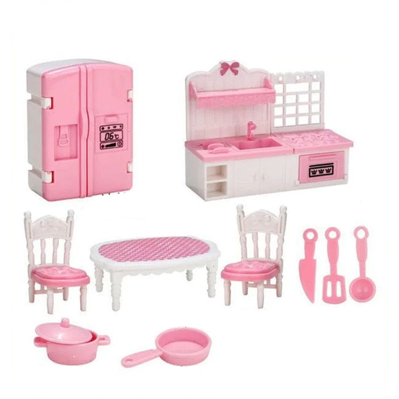 A pink miniature dollhouse furniture set including a refrigerator, kitchen counter, and various utensils.