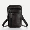 A black vintage genuine cowhide leather crossbody sling bag with a zipper and adjustable strap.