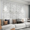 A modern living room wall featuring white marble patterned wallpaper and a light gray sofa.