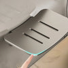 A silver aluminum wall-mounted soap dish with three drainage slots and a glowing blue light is shown against a neutral backgr