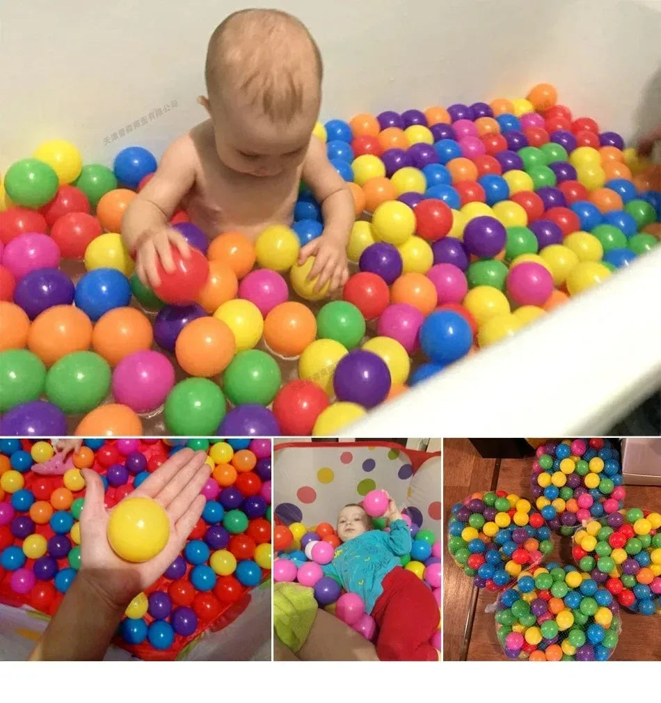 A large quantity of colorful soft play balls in various bright colors are visible in a white tub and in a hand.