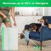 A green mop pad refill is shown being used on a wooden floor, with a dog resting on a blue chair.