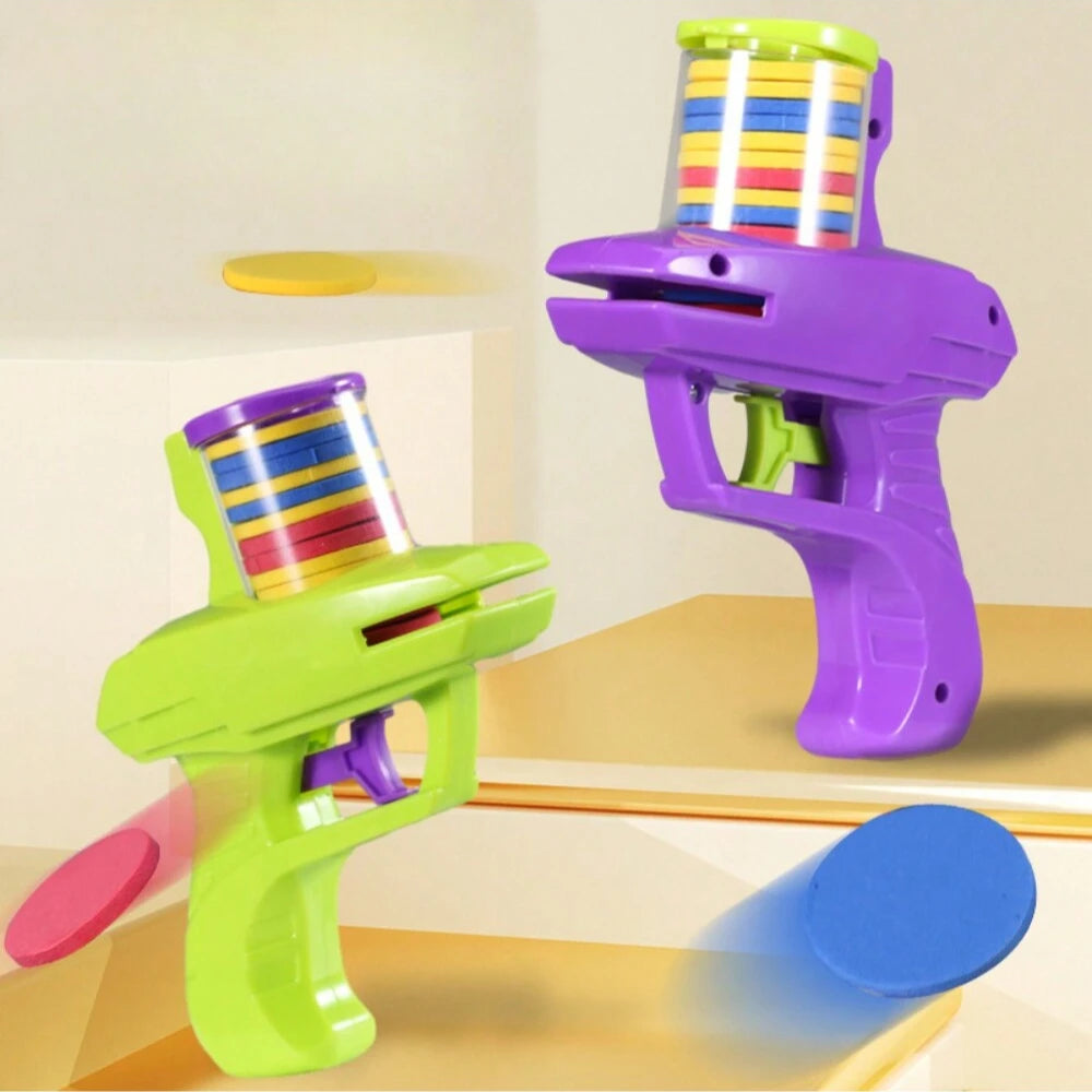 A purple foam disc launcher toy with a colorful disc being launched, next to a green version.