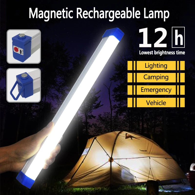 A hand holds a bright white magnetic rechargeable lamp illuminating a dark outdoor scene near a tent.