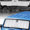 A blue Jeep Wrangler windshield with a white custom-fit sunshade installed.