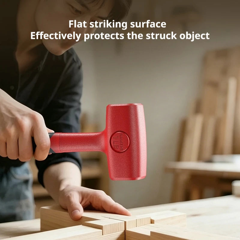 A hand is using a red rubber mallet to strike a wooden surface for tile work or DIY projects.