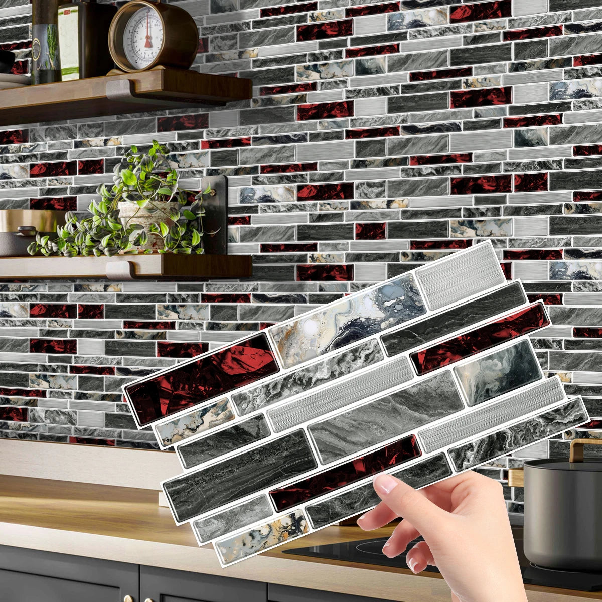 A hand holds a rectangular peel-and-stick tile sticker featuring marbled gray and black stone patterns against a dark subway 