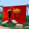 Une bannière rouge avec le logo McDonald's et un verre de boisson glacée avec des frites, exposé en extérieur.