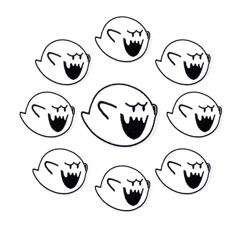 A set of ten embroidered iron-on patches depicting stylized skulls with open mouths and menacing expressions.