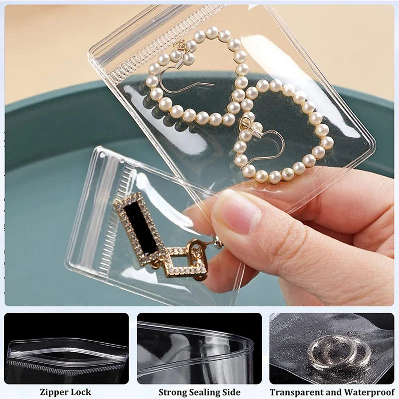 Clear self-sealing jewelry storage bags showing a pearl necklace and a gold charm inside