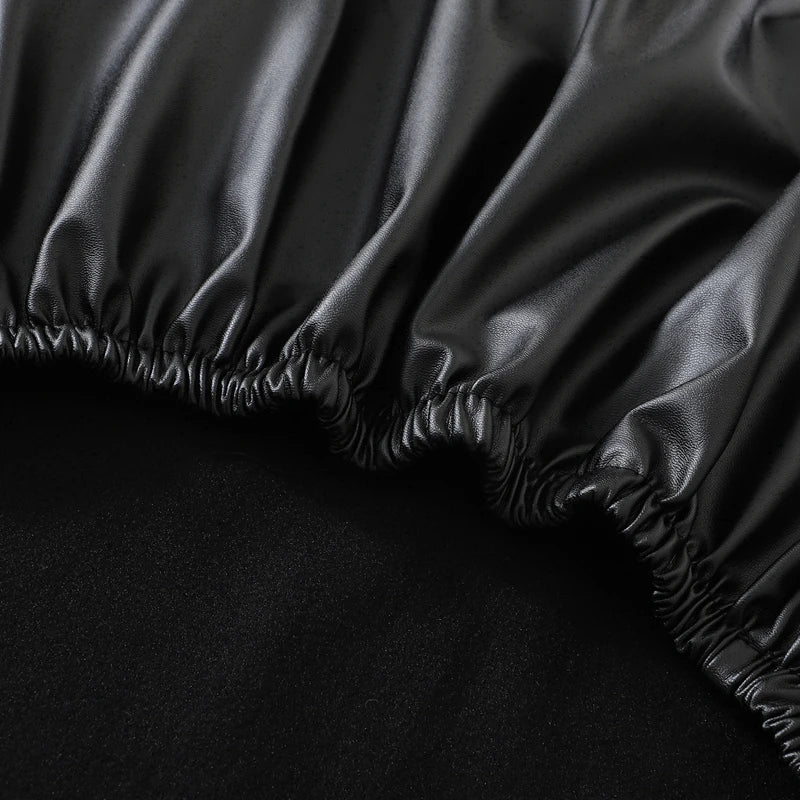Black waterproof PU stretch bench cover with an elastic edge shown in a close-up view.