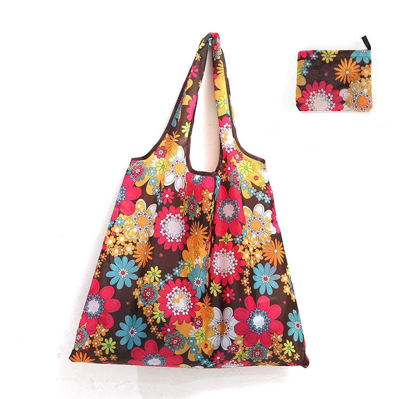 A colorful floral reusable shopping tote bag with a matching small carry pouch.