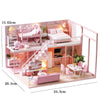 A pink wooden dollhouse miniature building kit featuring furniture and a bedroom setting.