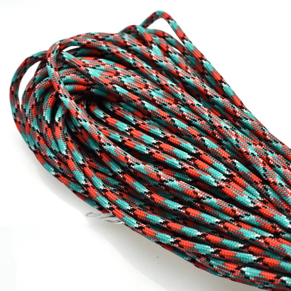 A coil of 100 ft, 7-strand paracord rope in black, orange, and teal colors.