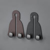 Two dark brown leather headrest hooks designed as a tidy organizer for bags, groceries, and coats