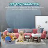 A felt pet toy organizer basket with wooden handles sits on a gray rug next to a pink sofa.