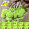 A collection of cute, soft green alien plush keychains with small ears and stems.