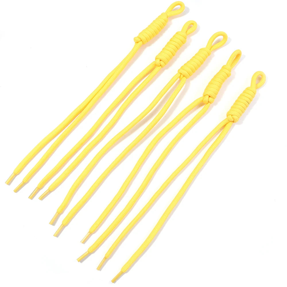 A collection of yellow braided nylon lanyards used for keychains and DIY crafts.