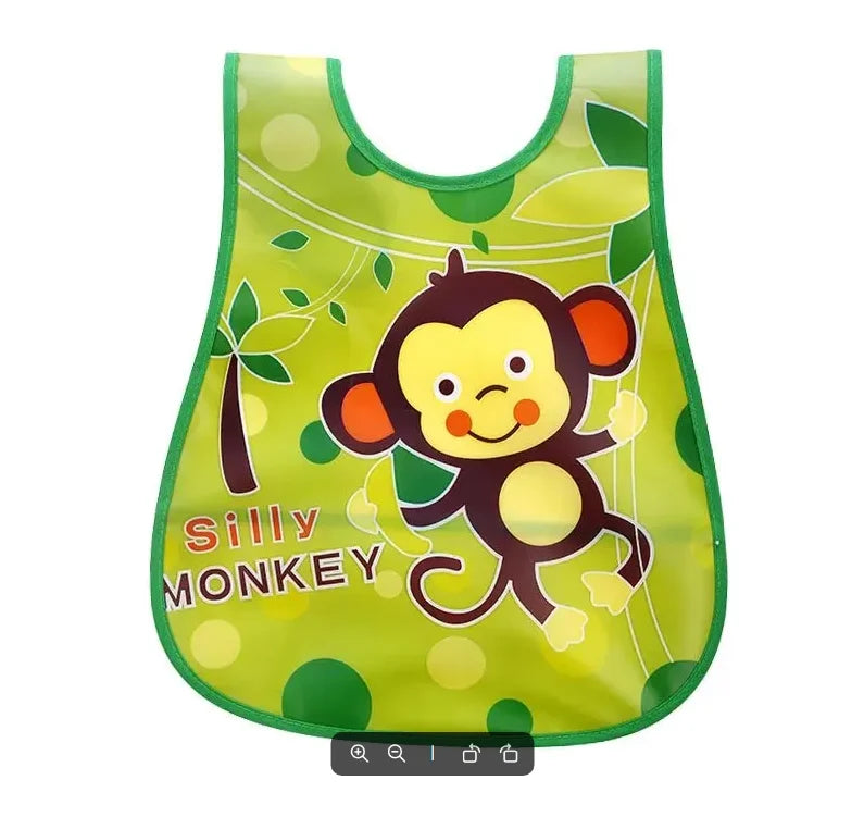 A bright green silicone bib featuring a cartoon monkey design for weaning toddlers.