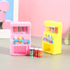 Pink and yellow interactive vending machine toy with play coins and colorful drinks