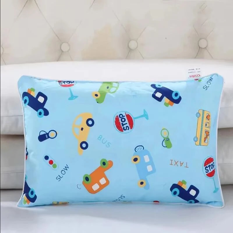 Light blue cartoon pillow featuring various vehicles like a bus, taxi, and other toys