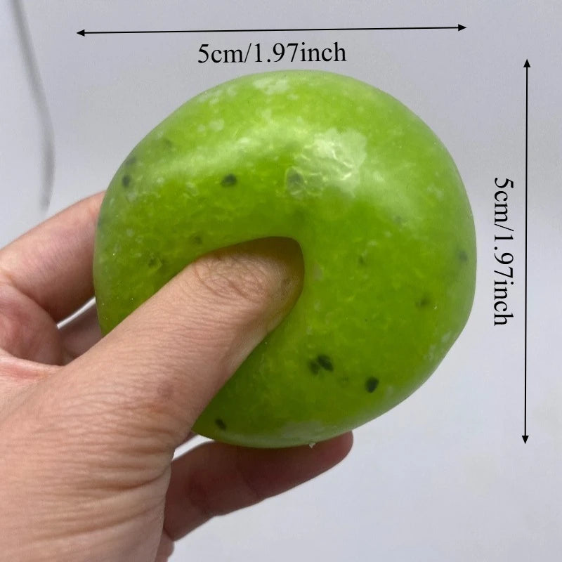 A hand holds a bright lime green squishy stress relief fidget ball with a curved shape.