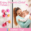 A smiling woman holds a baby while playing with colorful suction cup spinner sensory toys.