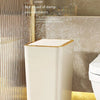 A white pop-up slim trash can with a translucent cover is shown next to a toilet.