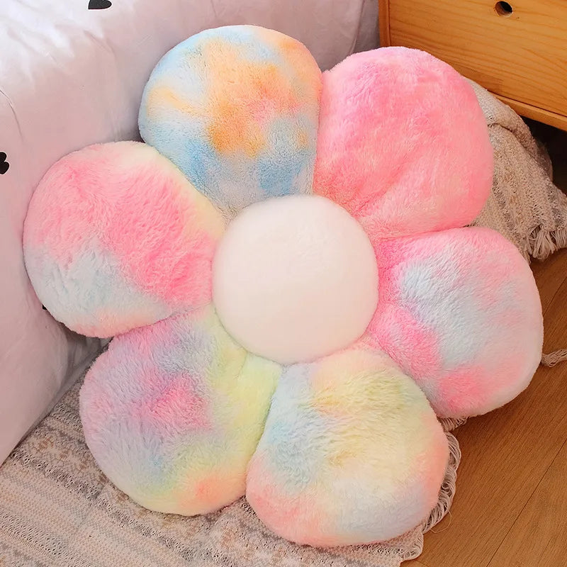 A collection of colorful, fluffy sunflower-themed plush pillows in pink, yellow, and blue hues.