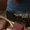 A close-up of a brown leather folding knife case with a copper buckle, showing its texture and craftsmanship.