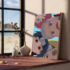A canvas art print featuring stylized anime characters in vintage style, displayed on a wooden shelf.
