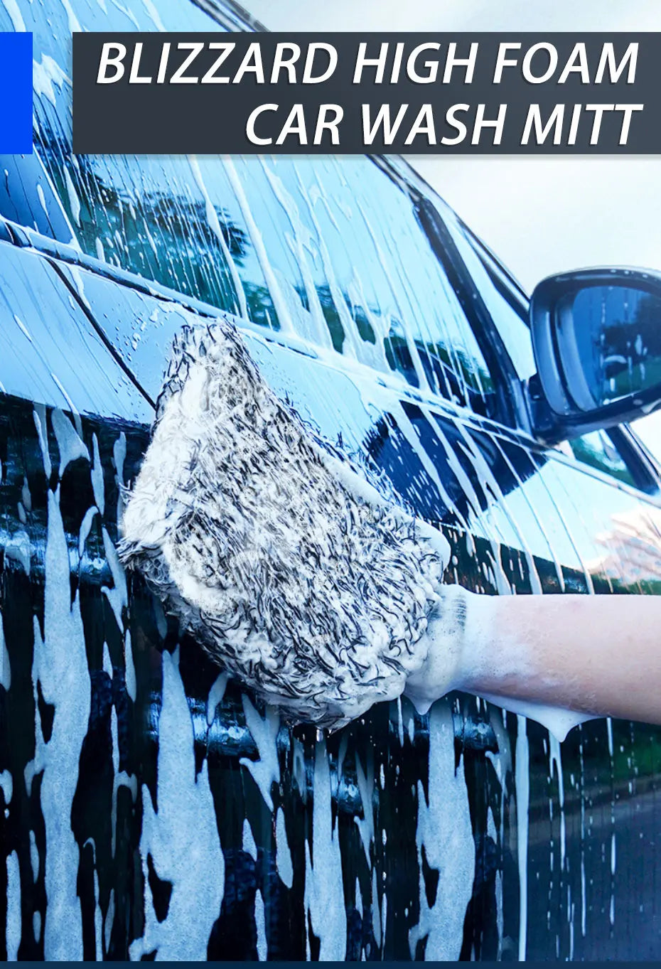 A hand wearing a blizzard high foam car wash mitt is cleaning water streaks off a car's surface.