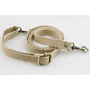 A beige canvas shoulder strap with a brass buckle is shown against a white background.