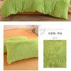 A set of bright lime green plush mink velvet duvet covers and sheets displayed on a bed.