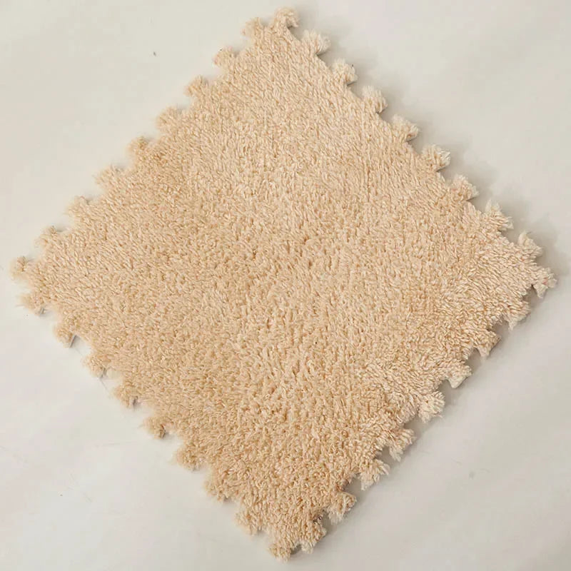 A square patch of light beige soft plush interlocking floor tiles.