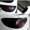 Close-up view of a matte smoke vinyl wrap film applied to a car's headlight and taillight assembly.