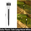A vertical view of a black solar plastic tube lamp used as a garden path light.