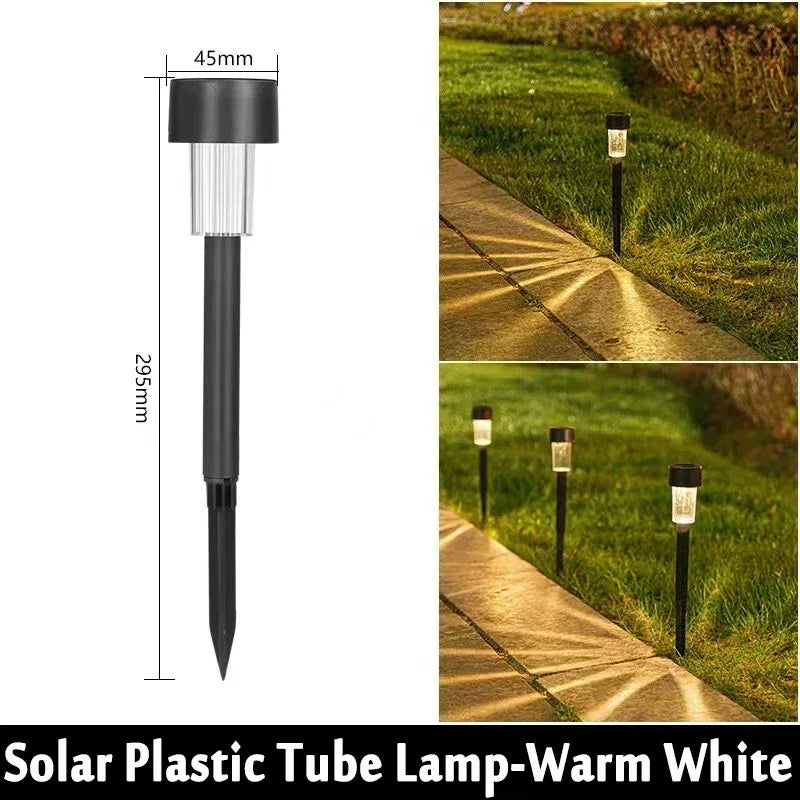 A vertical view of a black solar plastic tube lamp used as a garden path light.