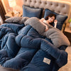 A woman is relaxing under a cozy double-sided velvet warm quilt blanket in a bedroom setting.