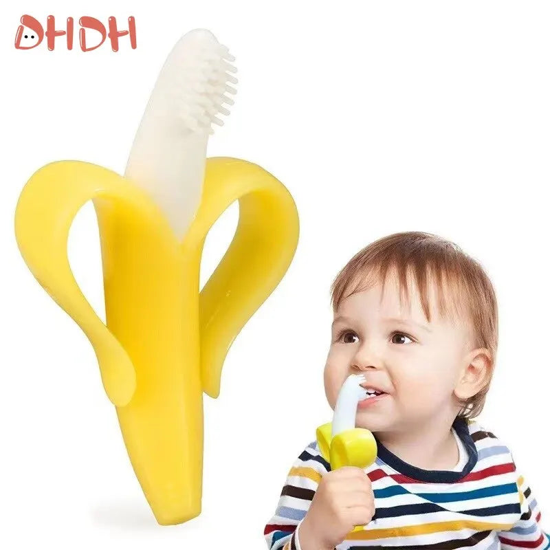 A yellow banana-shaped silicone baby teether and training toothbrush being held by a baby.