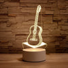 A glowing outline of an acoustic guitar is displayed on a round LED night light base.