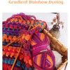 A close-up of vibrant gradient rainbow dyed wool yarn skeins used for knitting or crochet projects.
