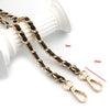 Gold and black universal chain strap for bags and phone cases shown next to a white cylindrical object