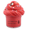 A jar of bright red scented slime topped with fruit pieces and colorful sprinkles.