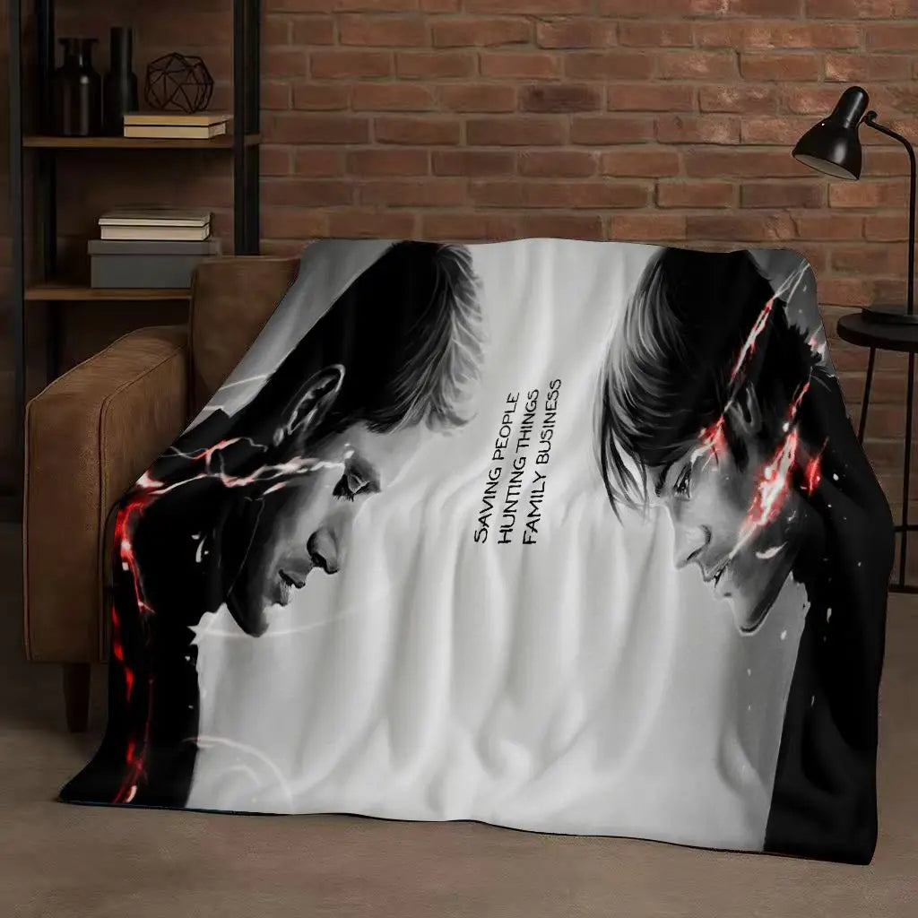 A black and white graphic blanket featuring a stylized face with red lightning effects.