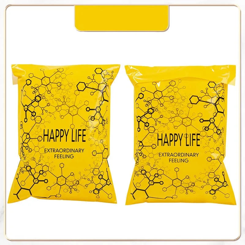 Two yellow self-sealing mailing bags featuring a black hexagonal pattern and the text HAPPY LIFE EXTRAORDINARY FEELING