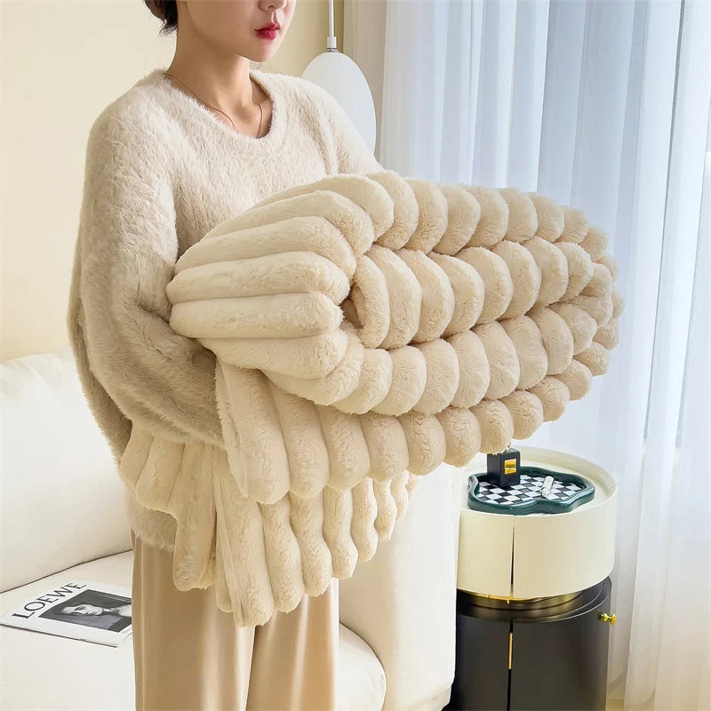 A beige plush cozy fleece blanket draped over a person, next to a white appliance.