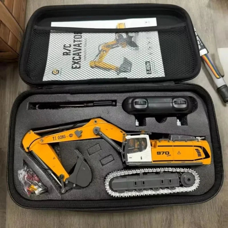 A black storage box contains a yellow 1:50 scale remote control excavator model with various tools and accessories.