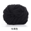 A ball of black chunky acrylic yarn used for knitting and crochet